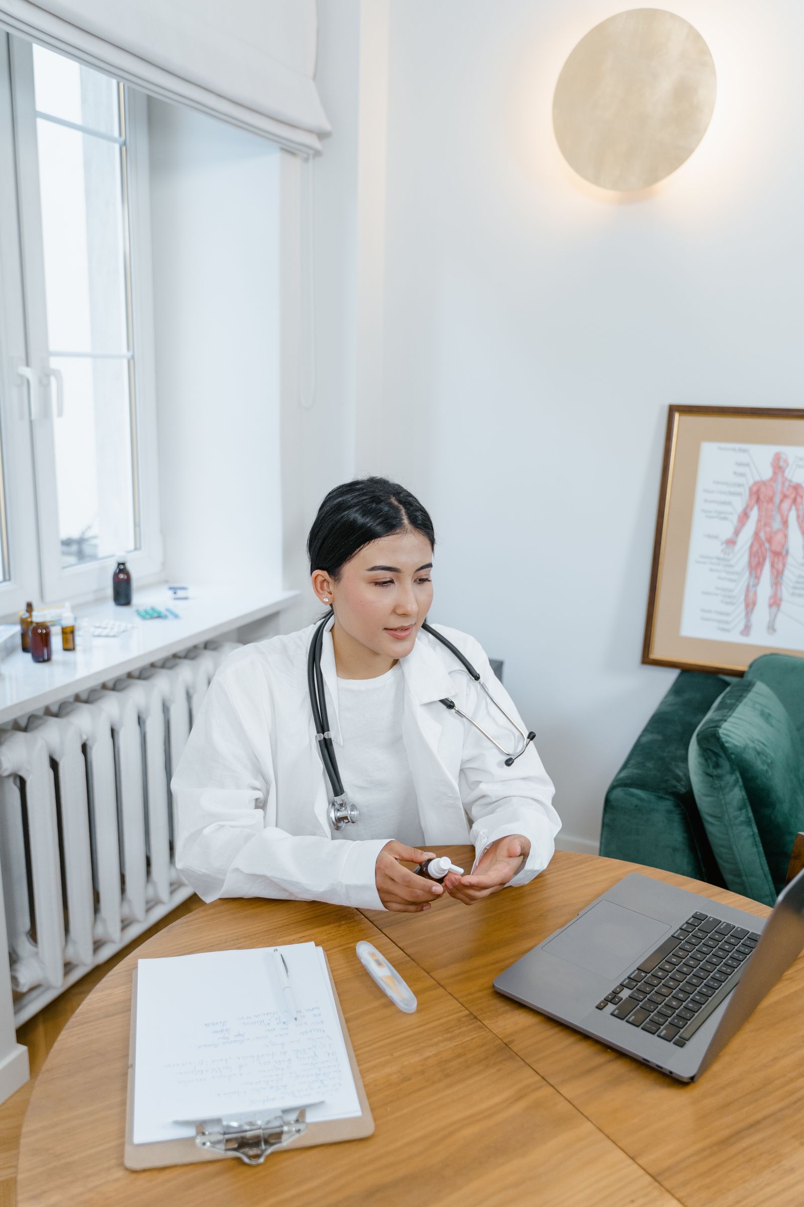 A doctor providing a video consultation from a laptop